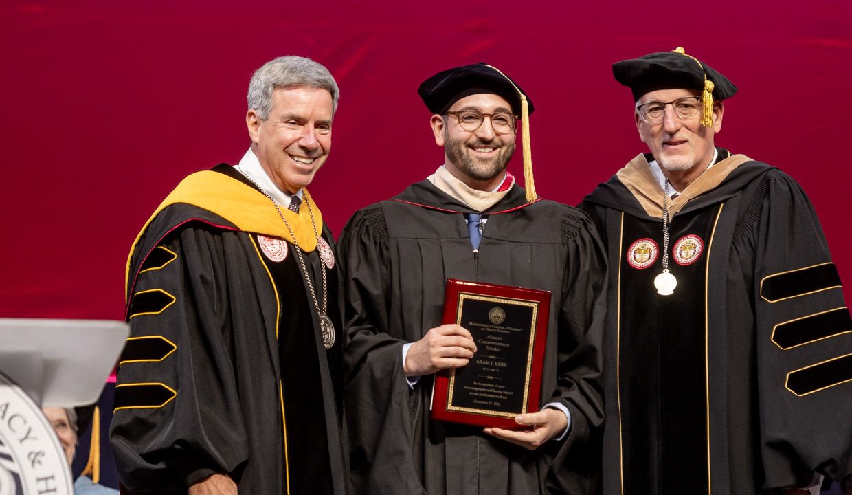 Students in cap and gowns at Commencement. 