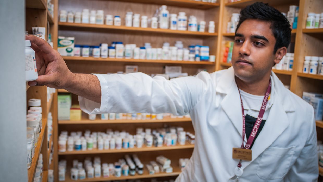 Male student in the MCPHS School of Pharmacy lab.