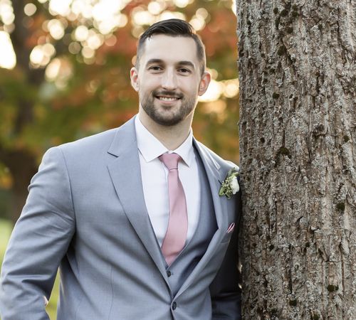 Michael Soden standing next to a tree.