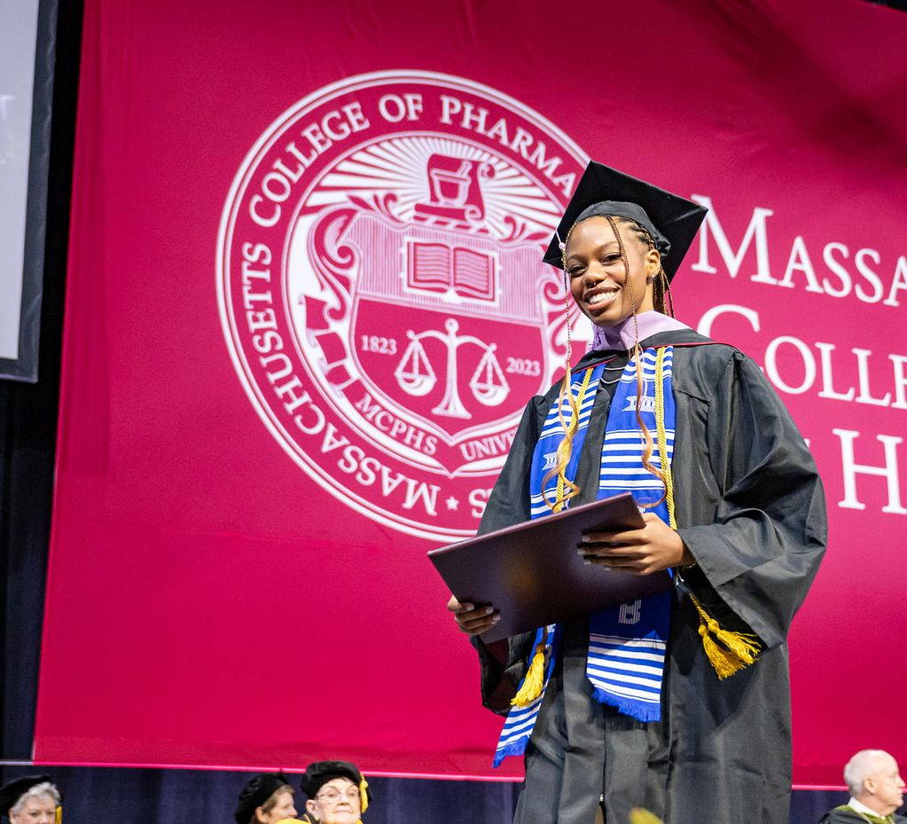 Smiling student at commencement. 