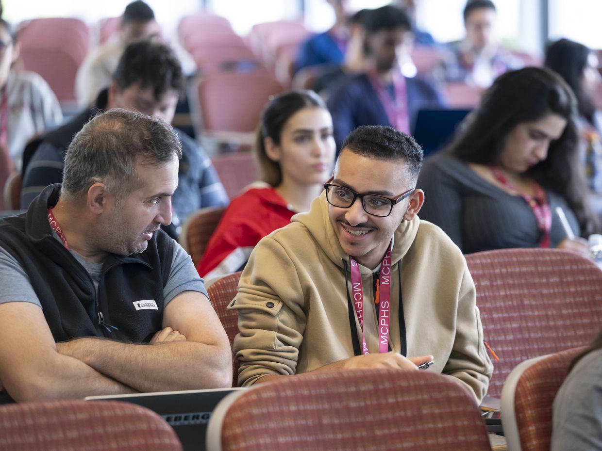 Students having a class in a big lecture hall