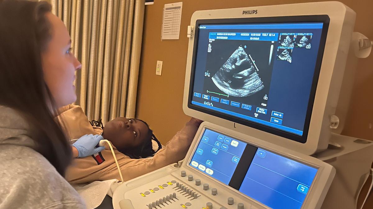 A girl gets a sonogram on her arm.