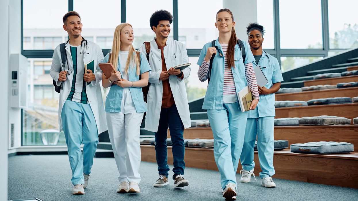 Group of medical and nursing students leaving the amphitheater after a lecture at medical university. 
