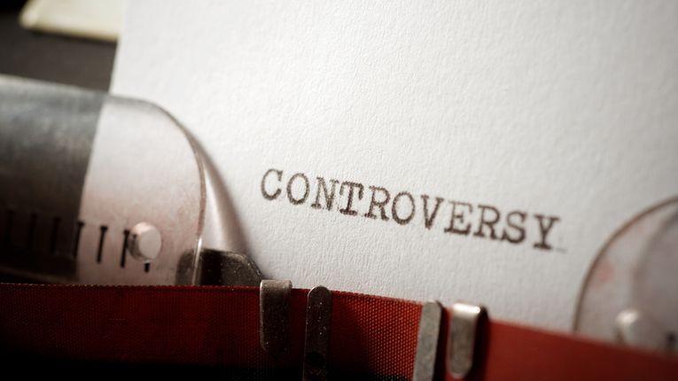 The word "Controversy" typed on paper.