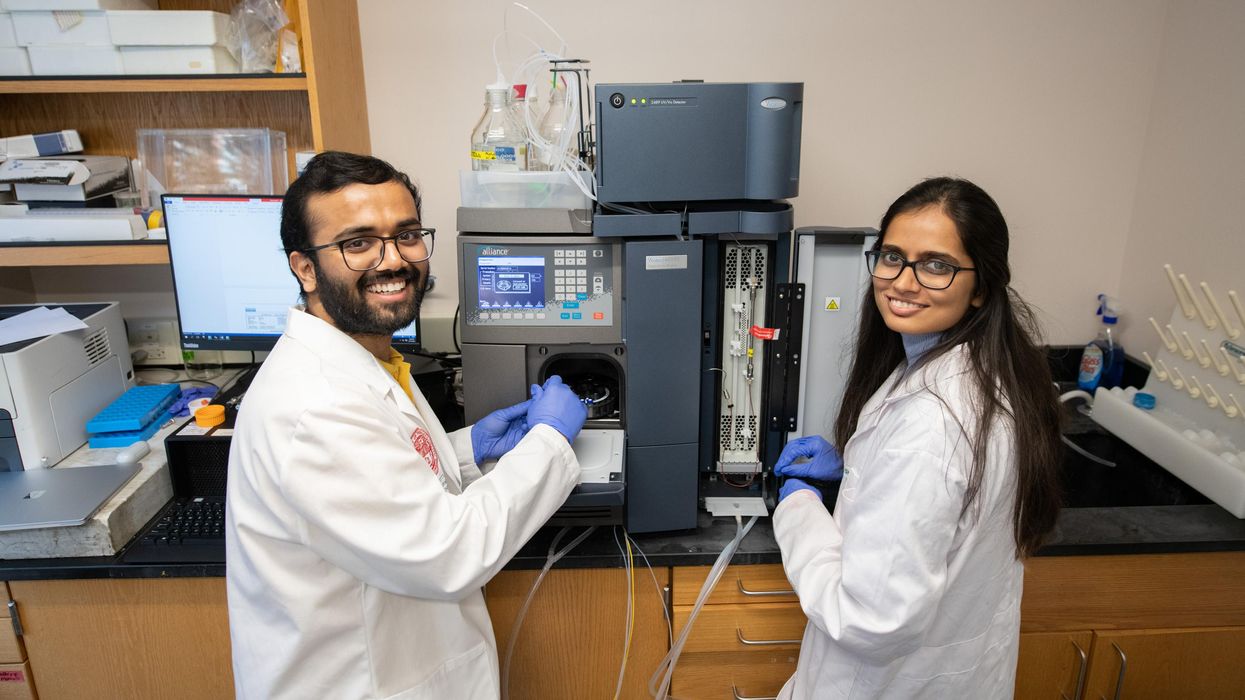 smiling female and male student in a lab