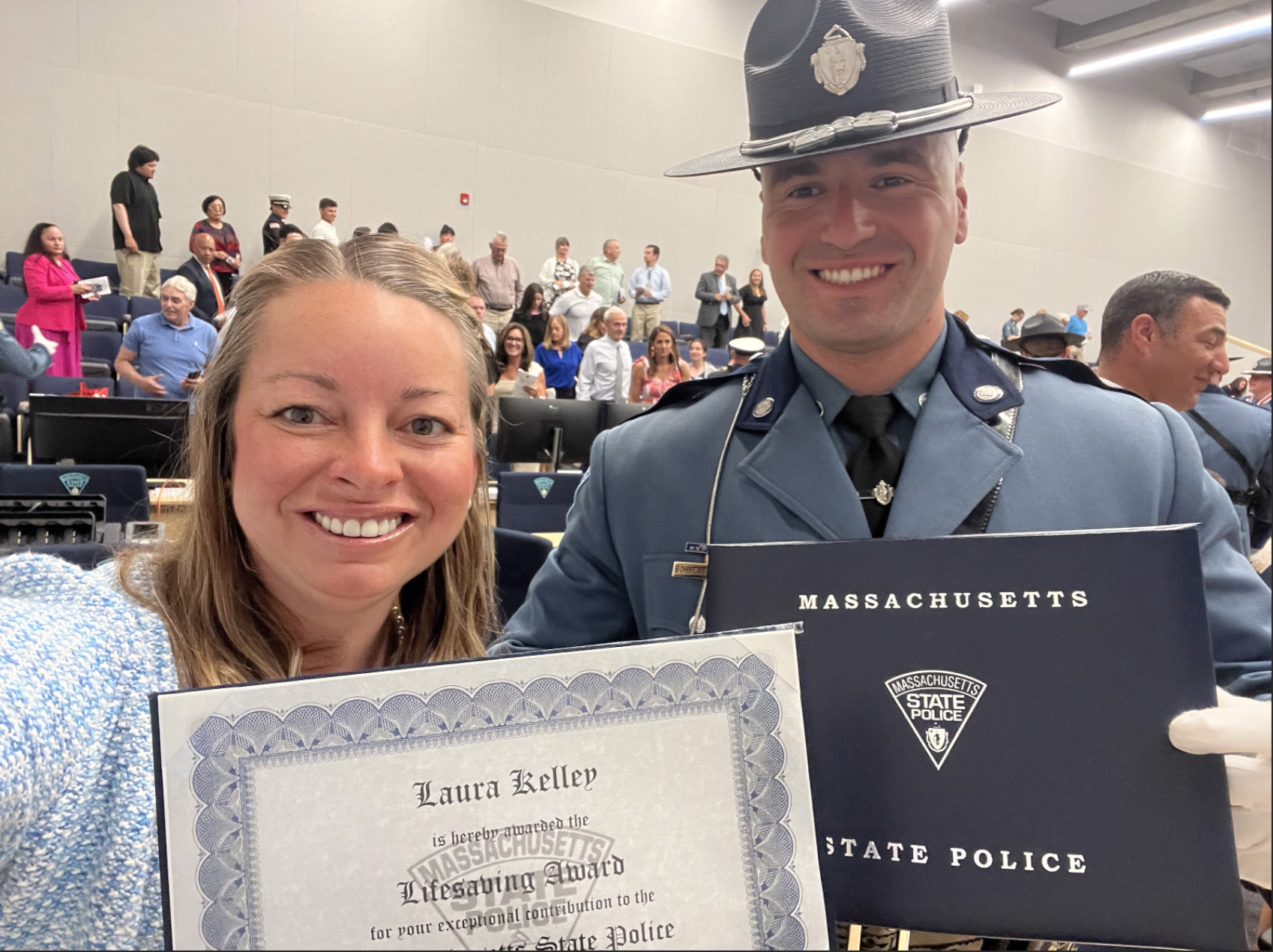 Laura Kelley and State Trooper Frederick J. Bohnenberger hold the Lifesaving Award.