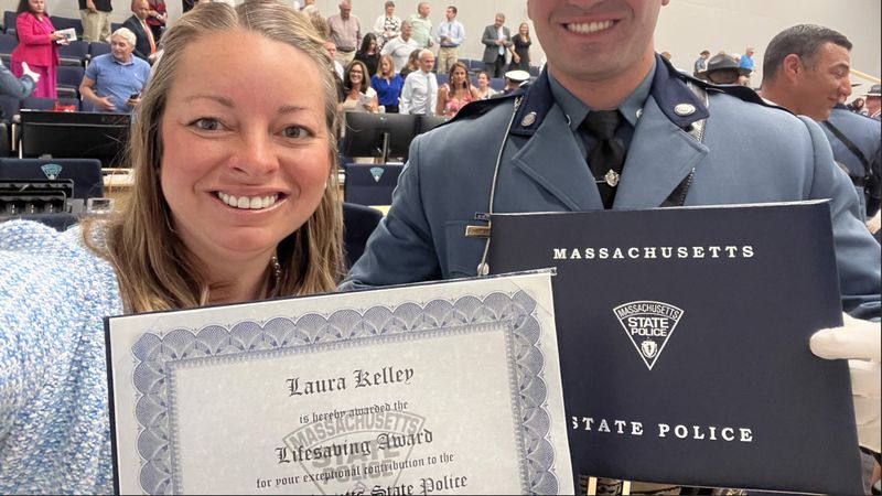 Laura Kelley and State Trooper Frederick J. Bohnenberger hold the Lifesaving Award.