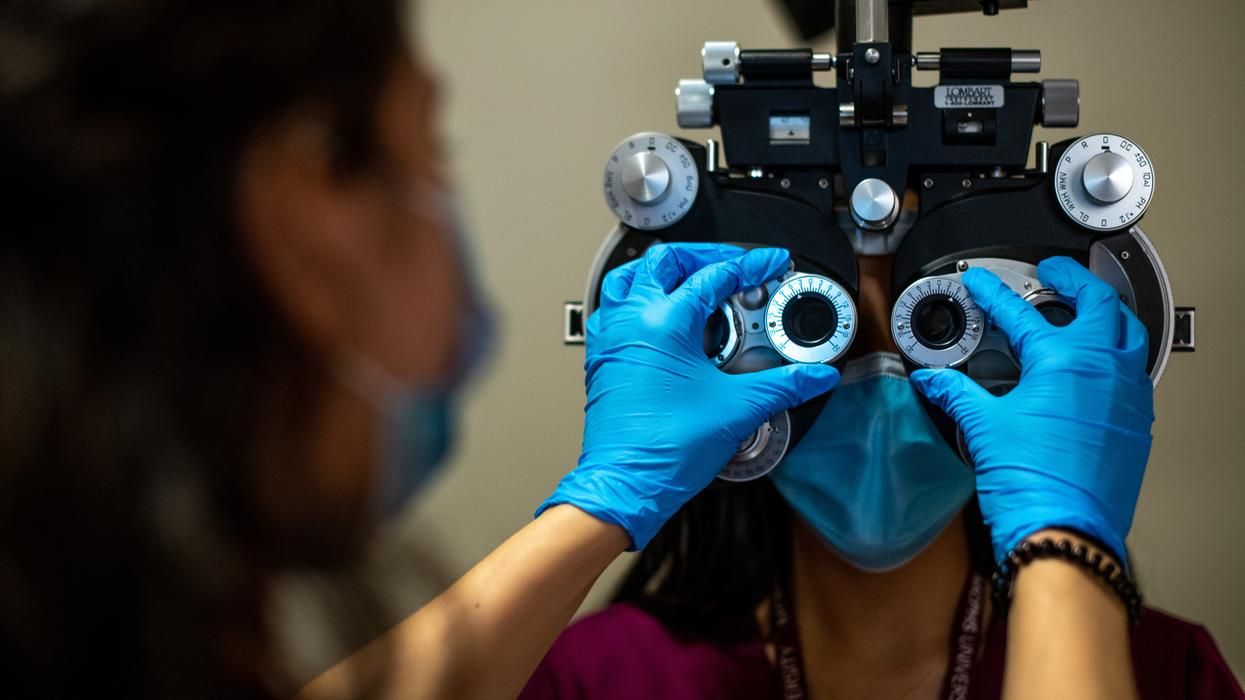 Close up of female patient being examined with a phoropter. 