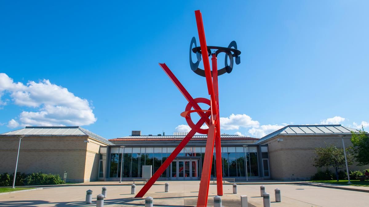 Exterior view of the Currier Museum of Art with a red steel sculpture