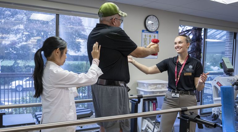 Physical Therapy students working with patients in lab setting