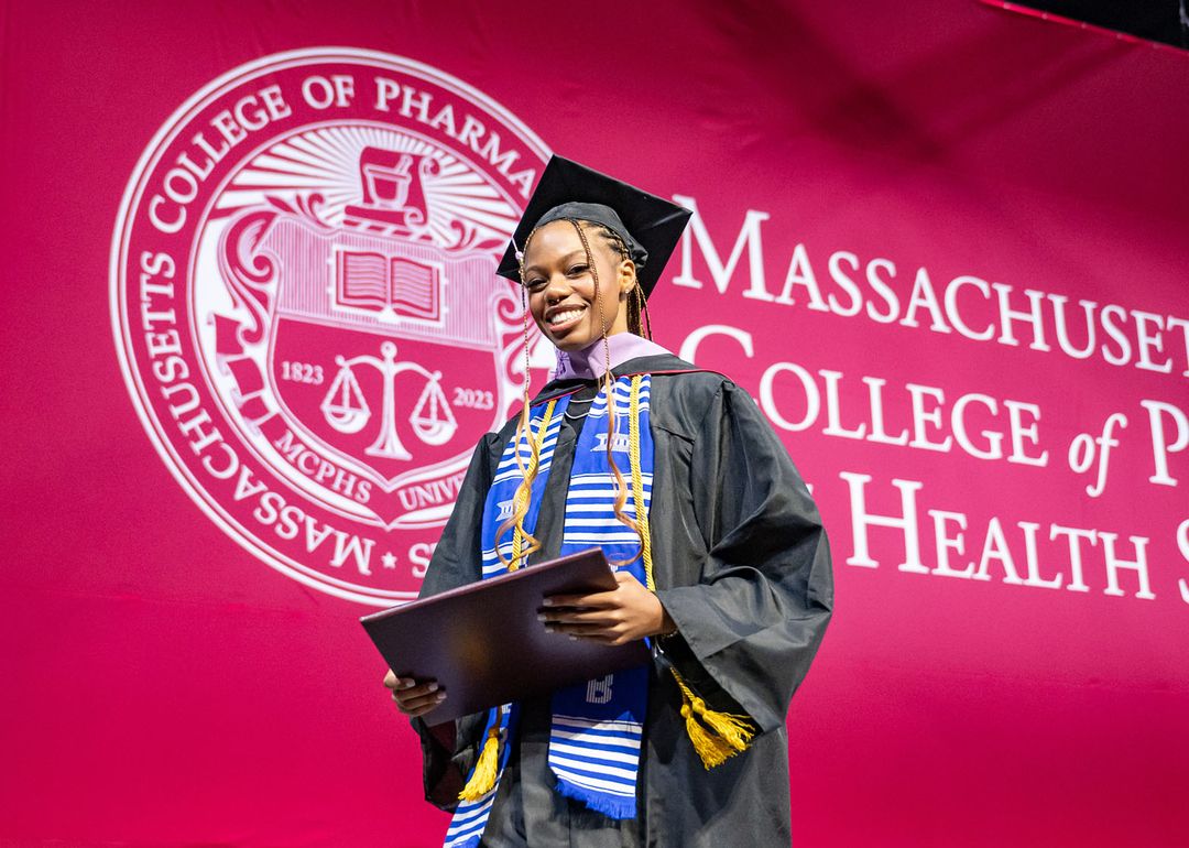 Smiling student at commencement. 