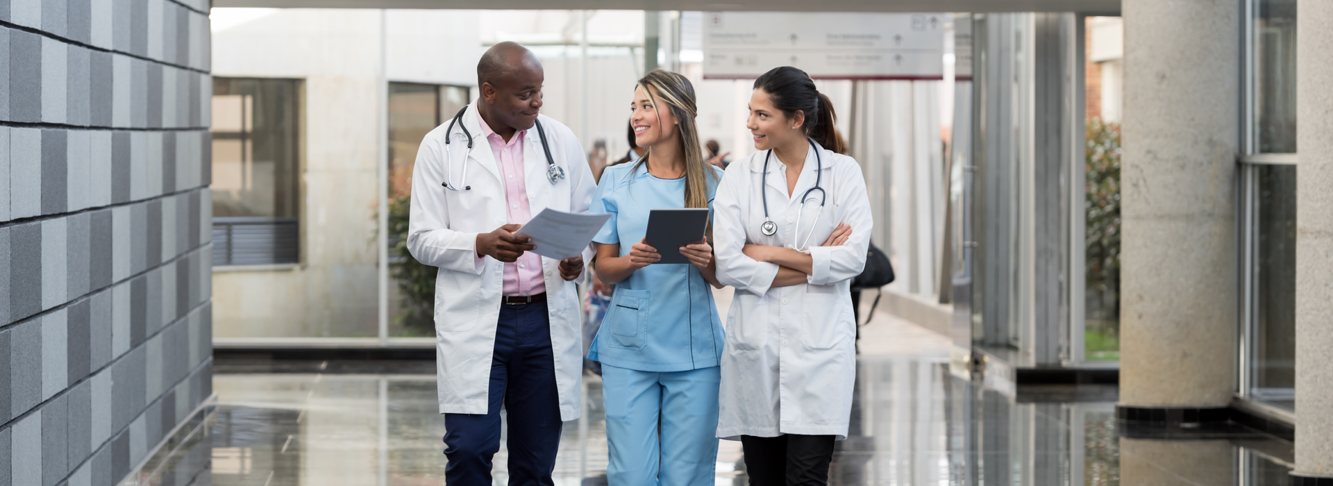 a group of doctors and a nurse walking down a hallway.	