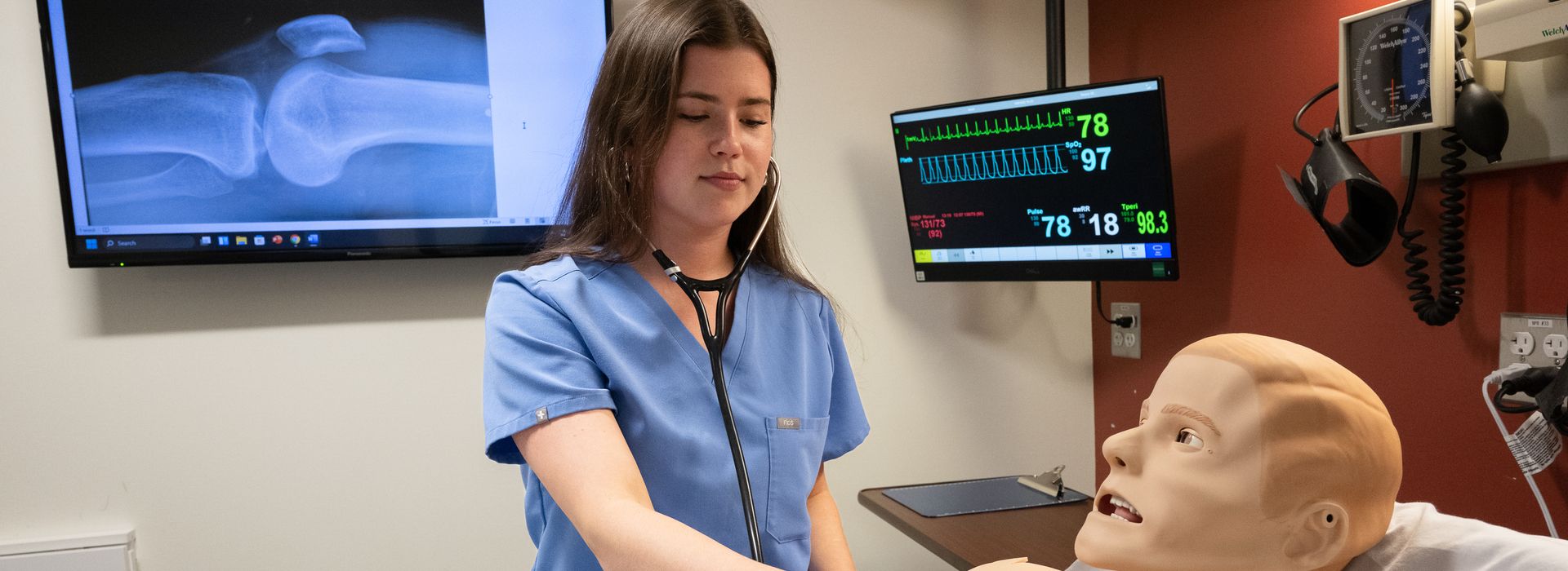 Physician Assistant students working in the simulation lab with high tech manikins.