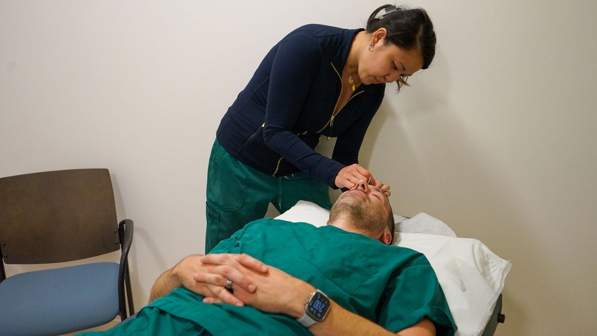 A patient receives acupuncture treatment in his face.