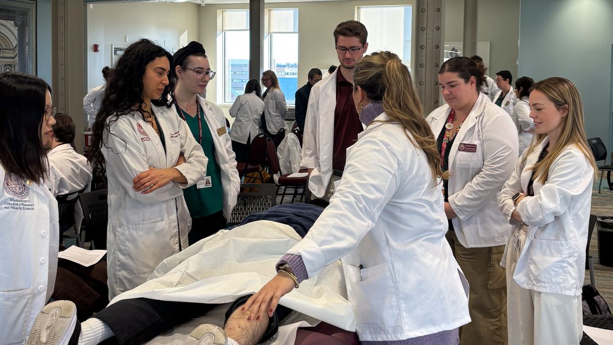 Acupuncture and PA Students look at patient.