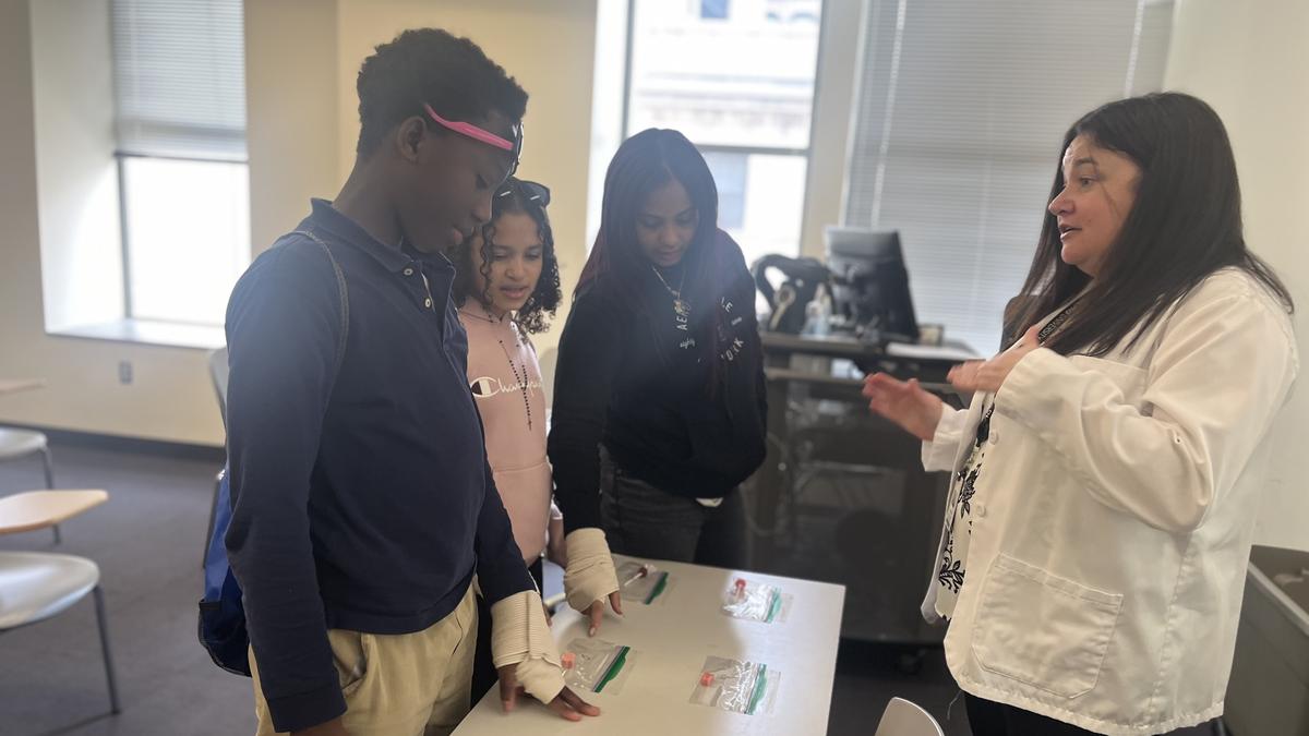 Sixth-graders from the Jacob Hiatt School in Worcester try to distinguish between medication and candy during an activity on a recent field trip to MCPHS.