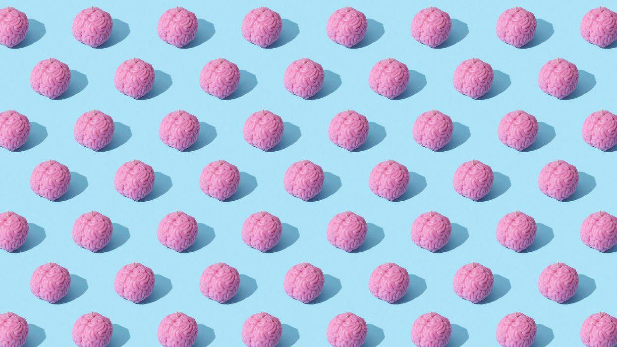 Repeating pattern of pink, brain-like objects on a light blue background