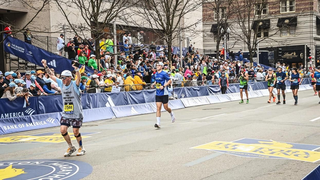 Bob Cargill crosses the finish line at the Boston Marathon.