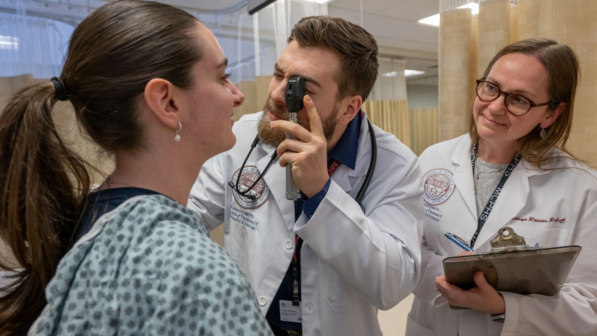 Physicians Assistant students hanging out in the library area on the Manchester campus and working in the PA lab.