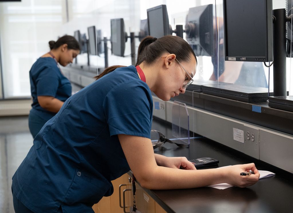 Pharmacy students working in lab.