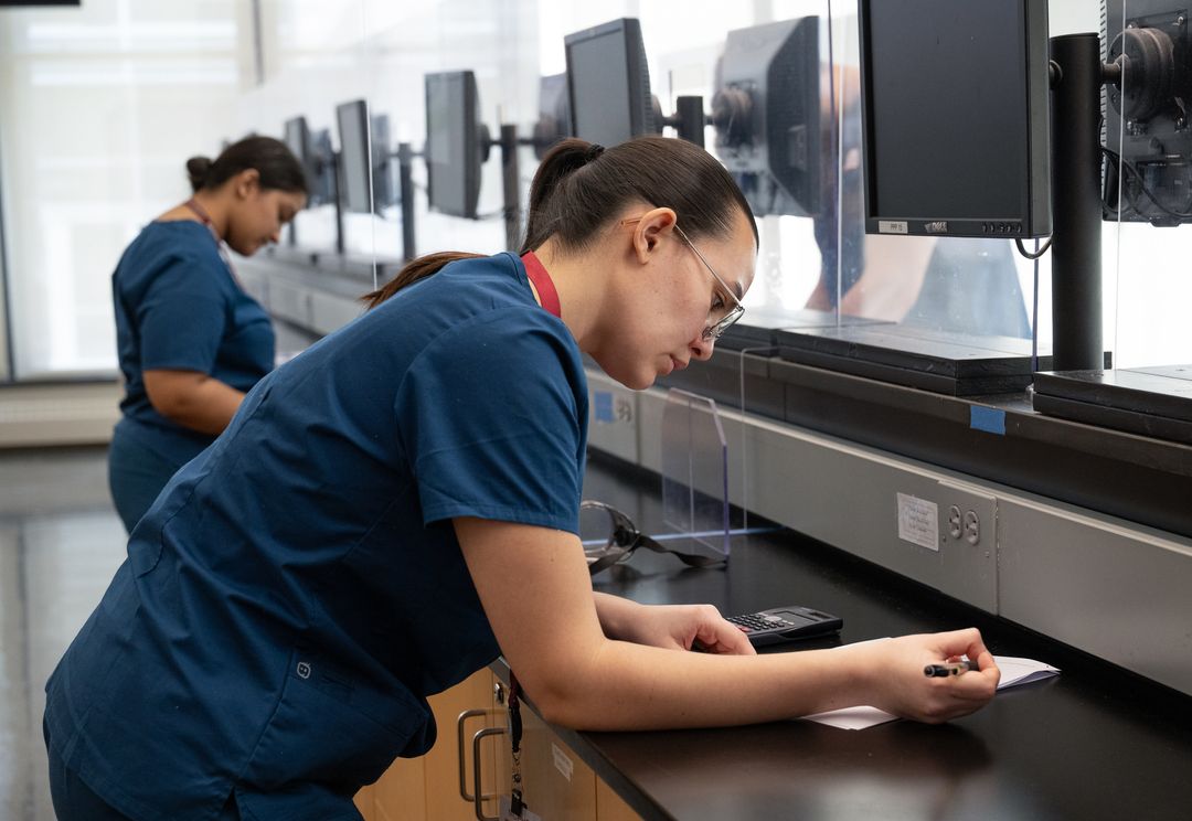Pharmacy students working in lab.