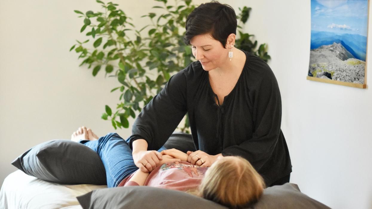Allison Camire uses Japanese acupuncture on female patient.