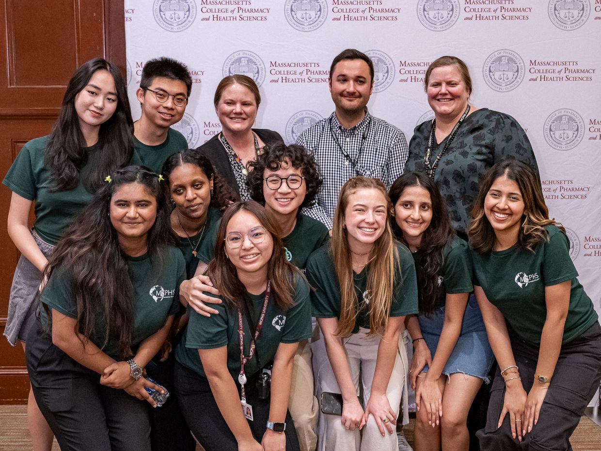 A group of smiling students at the Boston International Student Reception