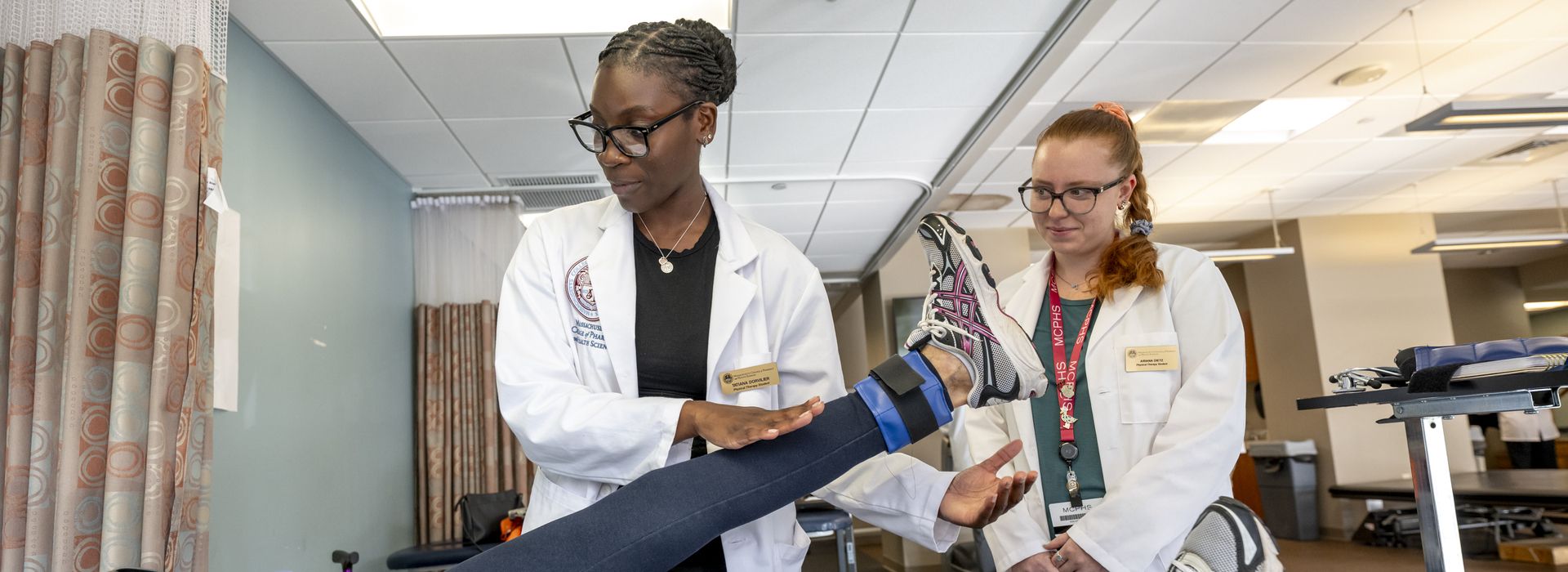 Physical Therapy students working with patients in lab setting