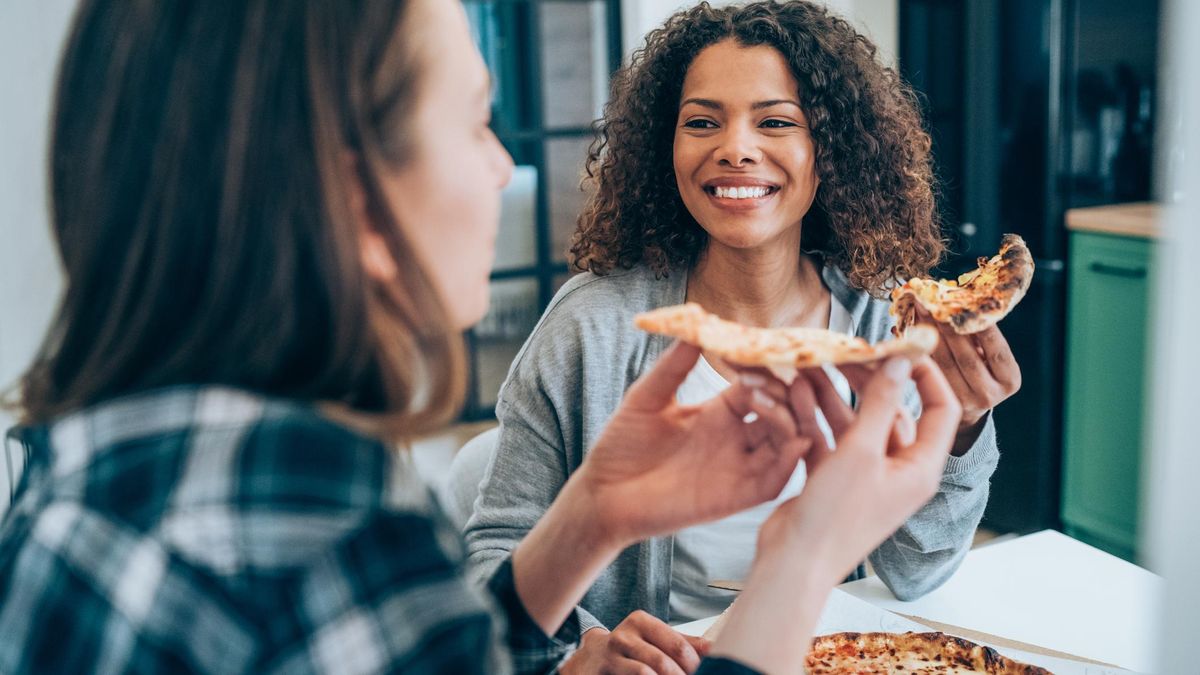 Two women sharing a pizza