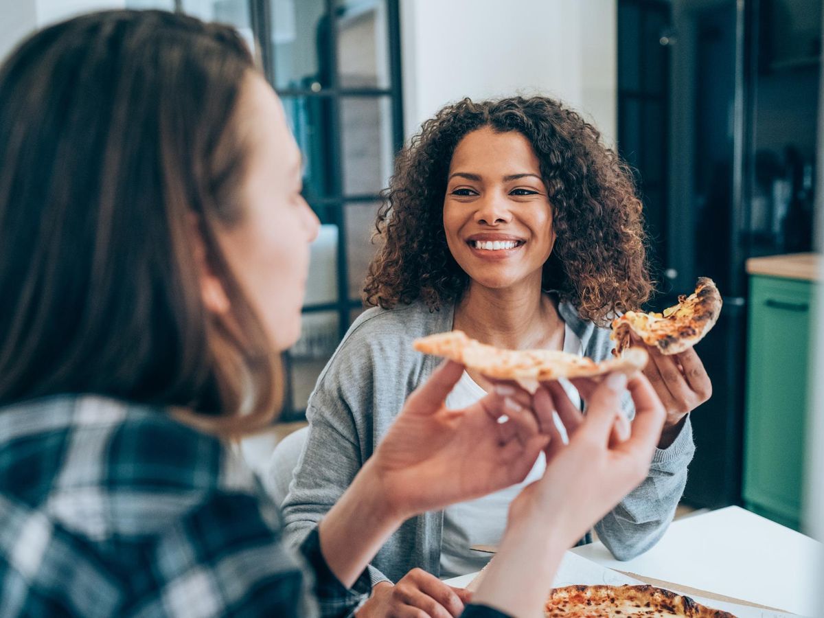 Two women sharing a pizza