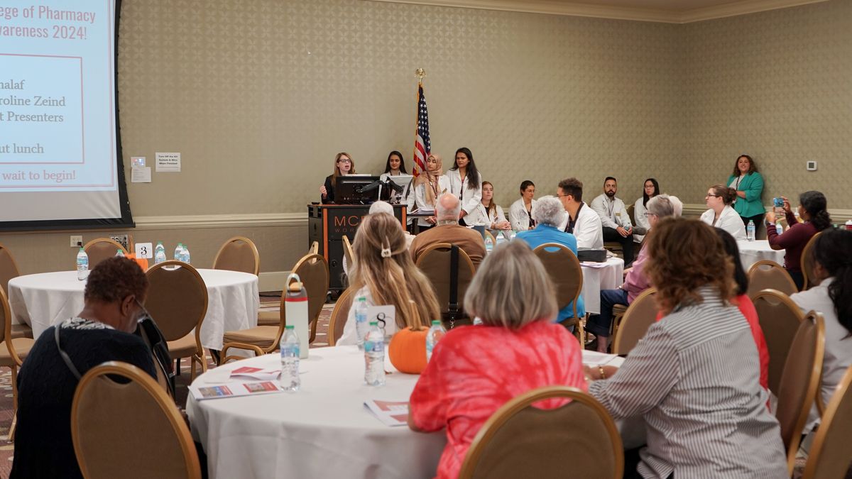 Community members listen to MCPHS students at the IPE Fall Awareness event.