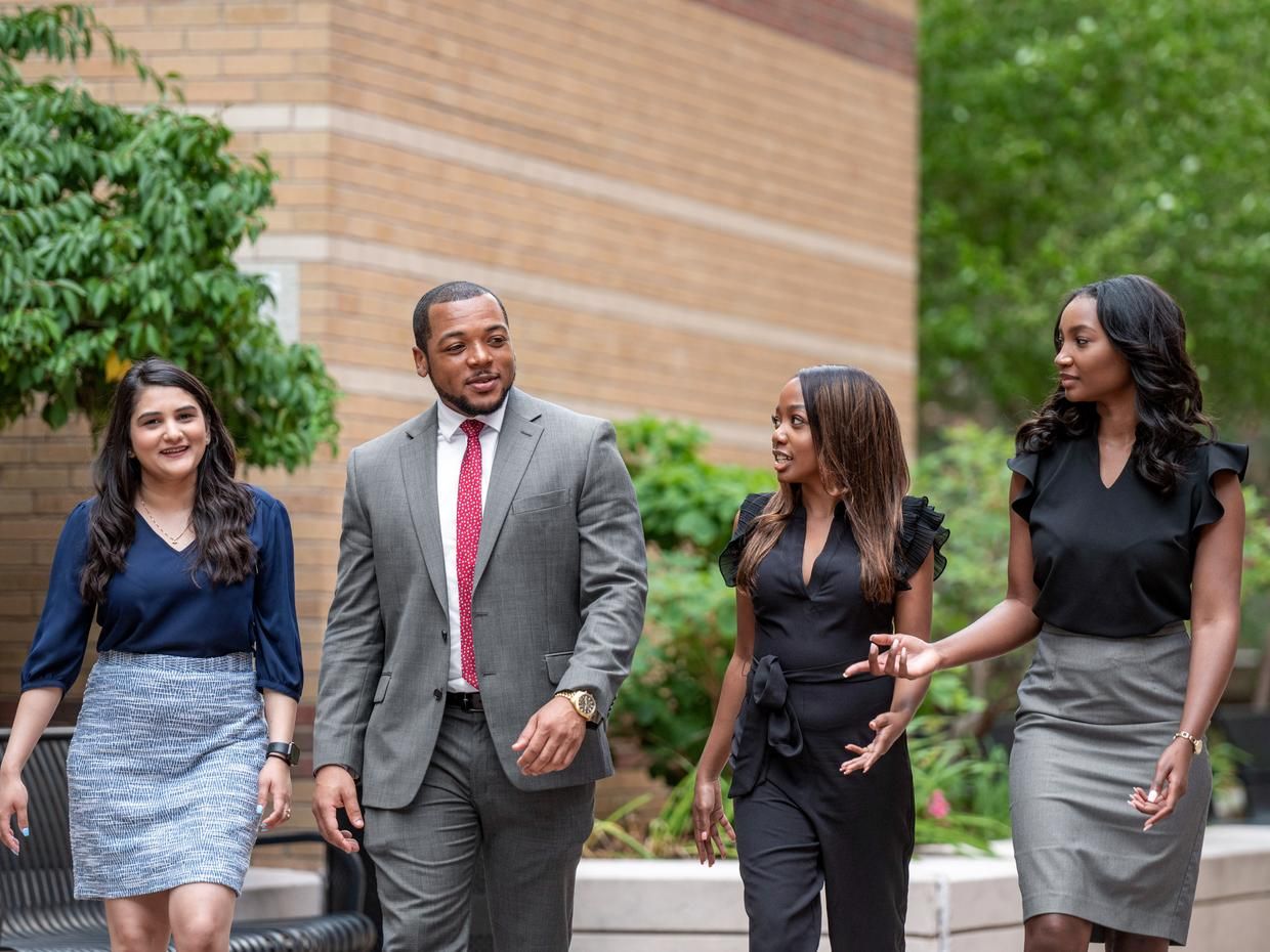 Professional dressed man and women walking down a street.