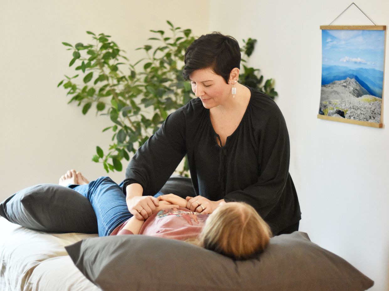 Allison Camire uses Japanese acupuncture on female patient.