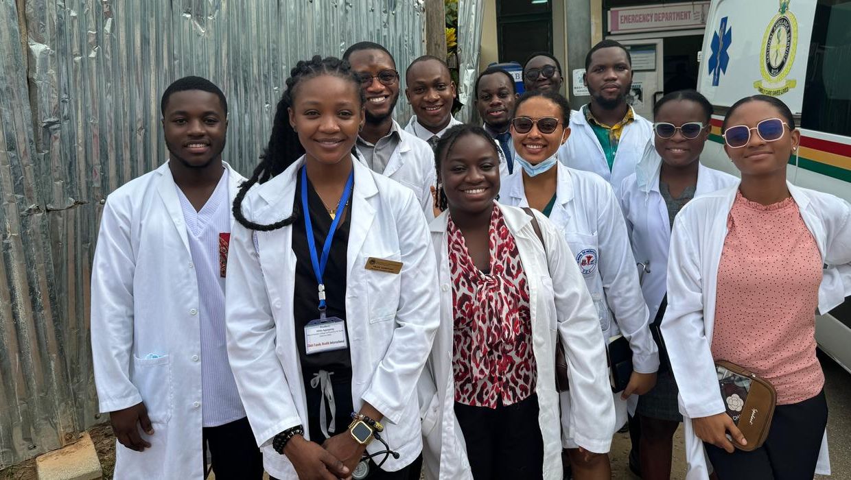 Students standing in front of an ambulance in Ghana.