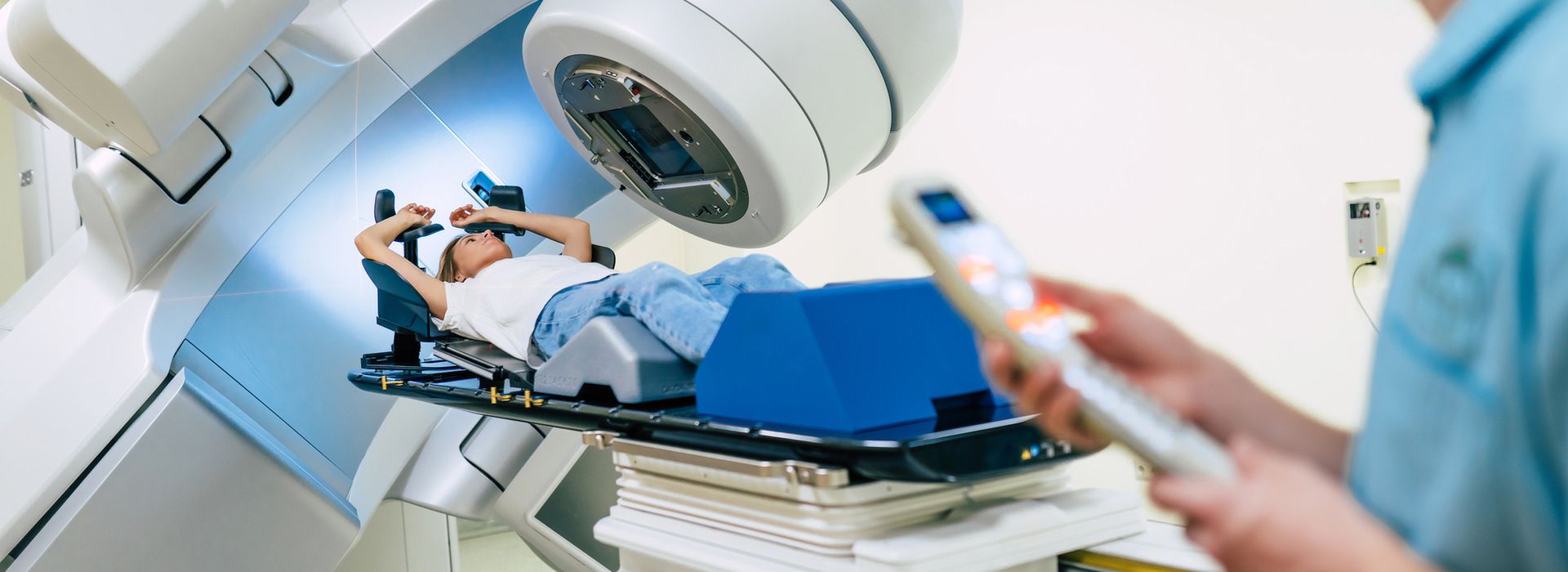 Professional doctors team working while the woman is undergoing radiation therapy for cancer