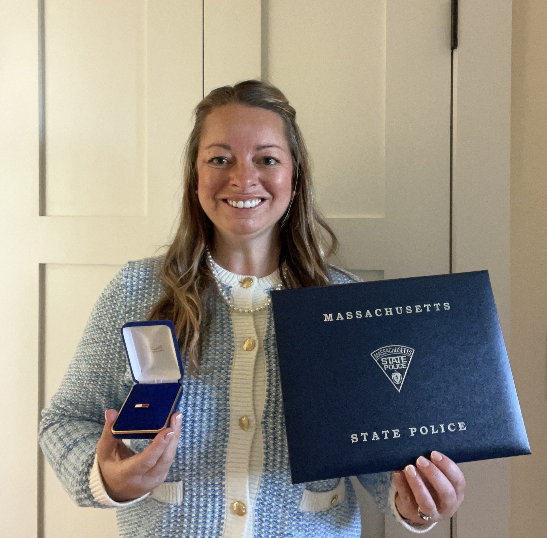 Laura Kelley holds her Massachusetts State Police Lifesaving Award.