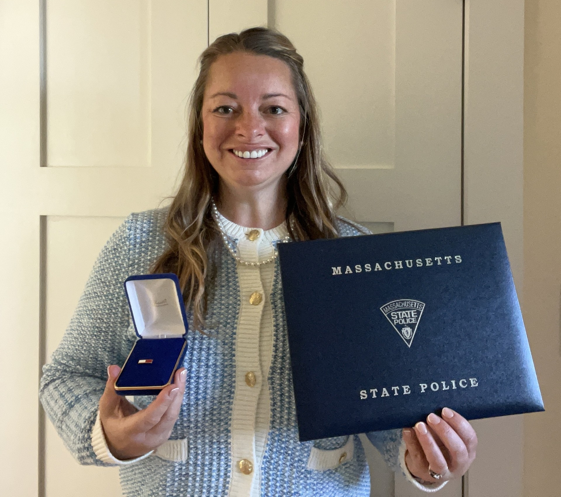 Laura Kelley holds her Massachusetts State Police Lifesaving Award.