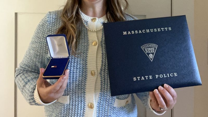Laura Kelley holds her Massachusetts State Police Lifesaving Award.
