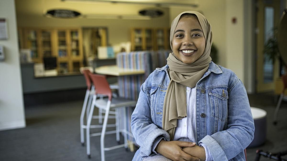 Smiling female student in the library. 