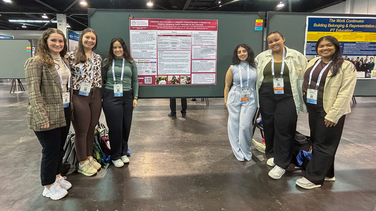 MCPHS Students stand in front of their presentation poster.