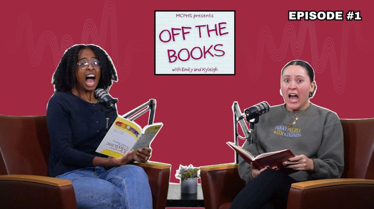 Two women scream while holding books.