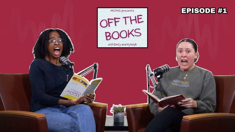Two women scream while holding books.