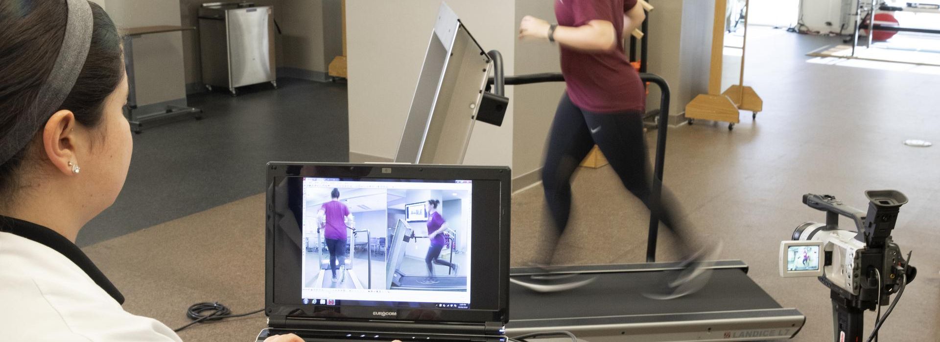 Physical Therapy student analyzing runner on a treadmill. 