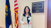 A pharmacy student wearing a white coat smiles for a photo outside the office of Vermont Senator Bernard Sanders.A pharmacy student wearing a white coat smiles for a photo outside the Capitol Hill office of Vermont Senator Bernard Sanders.