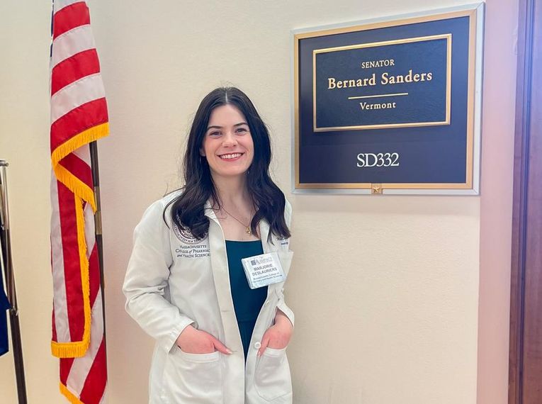 A pharmacy student wearing a white coat smiles for a photo outside the office of Vermont Senator Bernard Sanders.A pharmacy student wearing a white coat smiles for a photo outside the Capitol Hill office of Vermont Senator Bernard Sanders.
