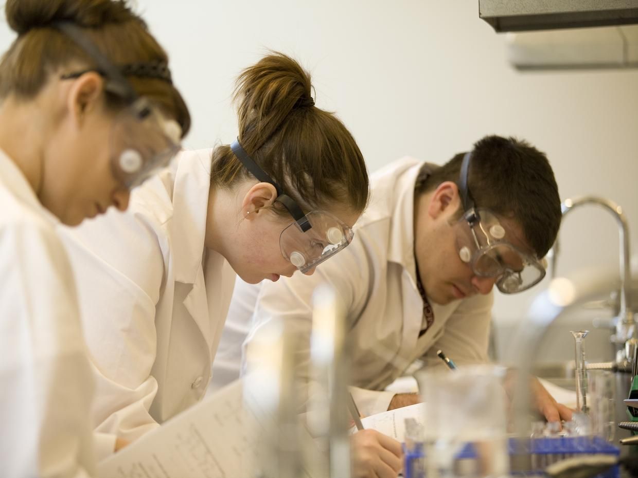 Three students in a lab. 