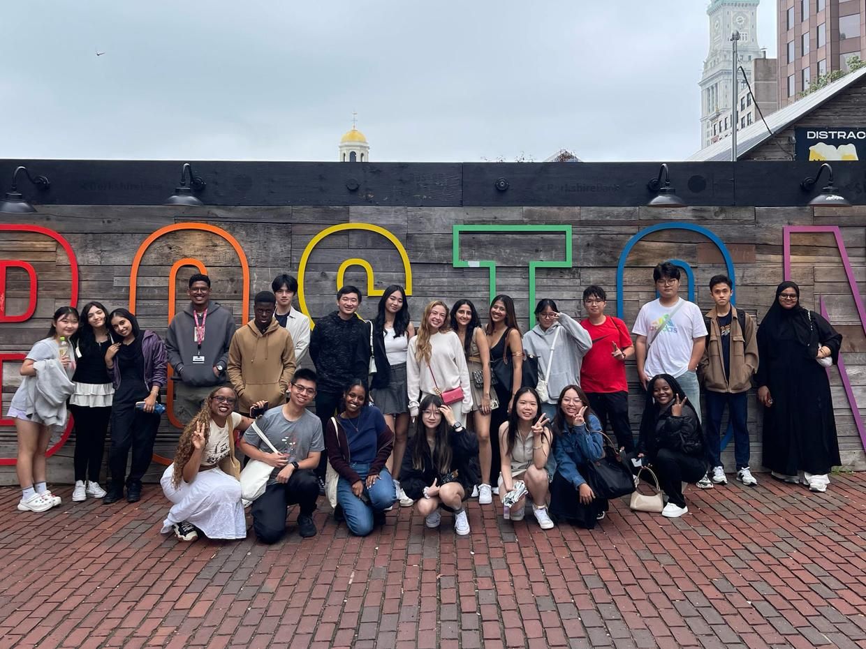 MCPHS International Students stand in front of Boston sign.