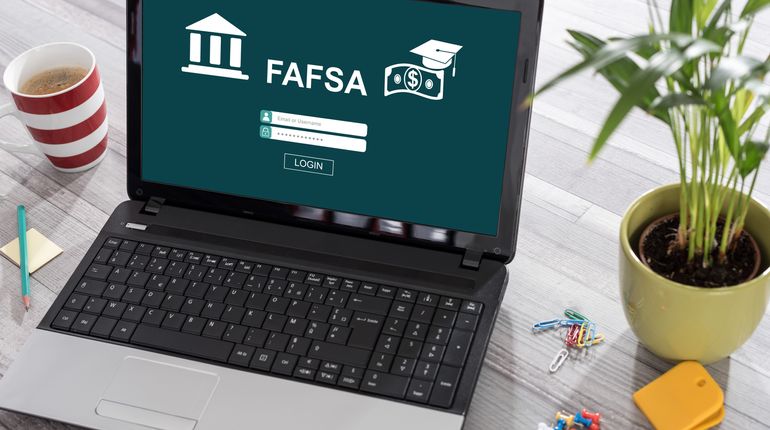 Laptop on a desk with fafsa concept on the screen