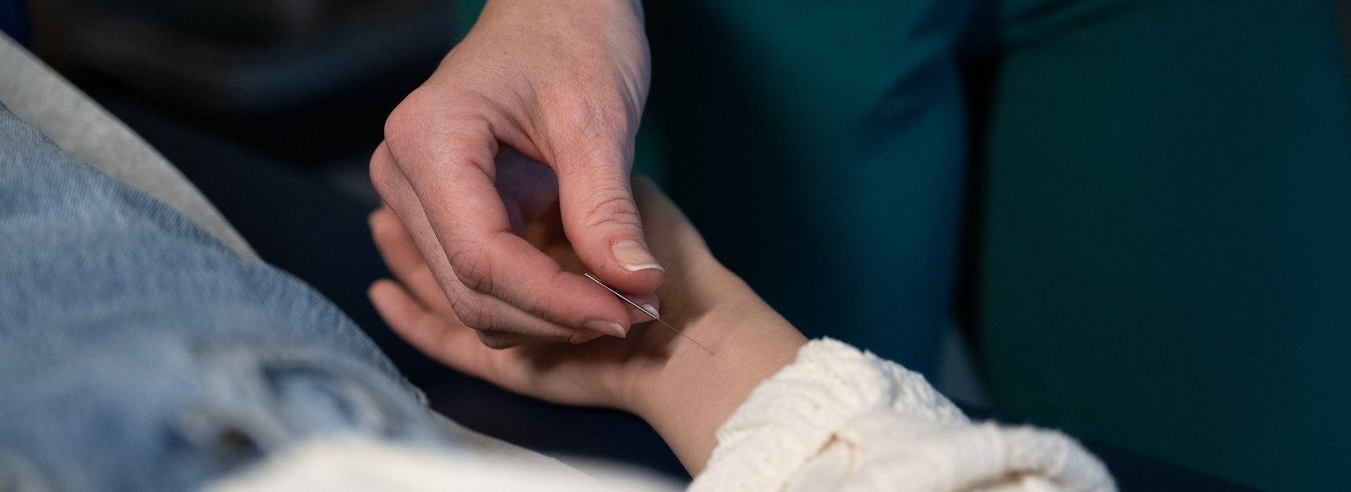 Students and faculty collaborating in the NESA acupuncture clinic on the MCPHS Worcester campus. 