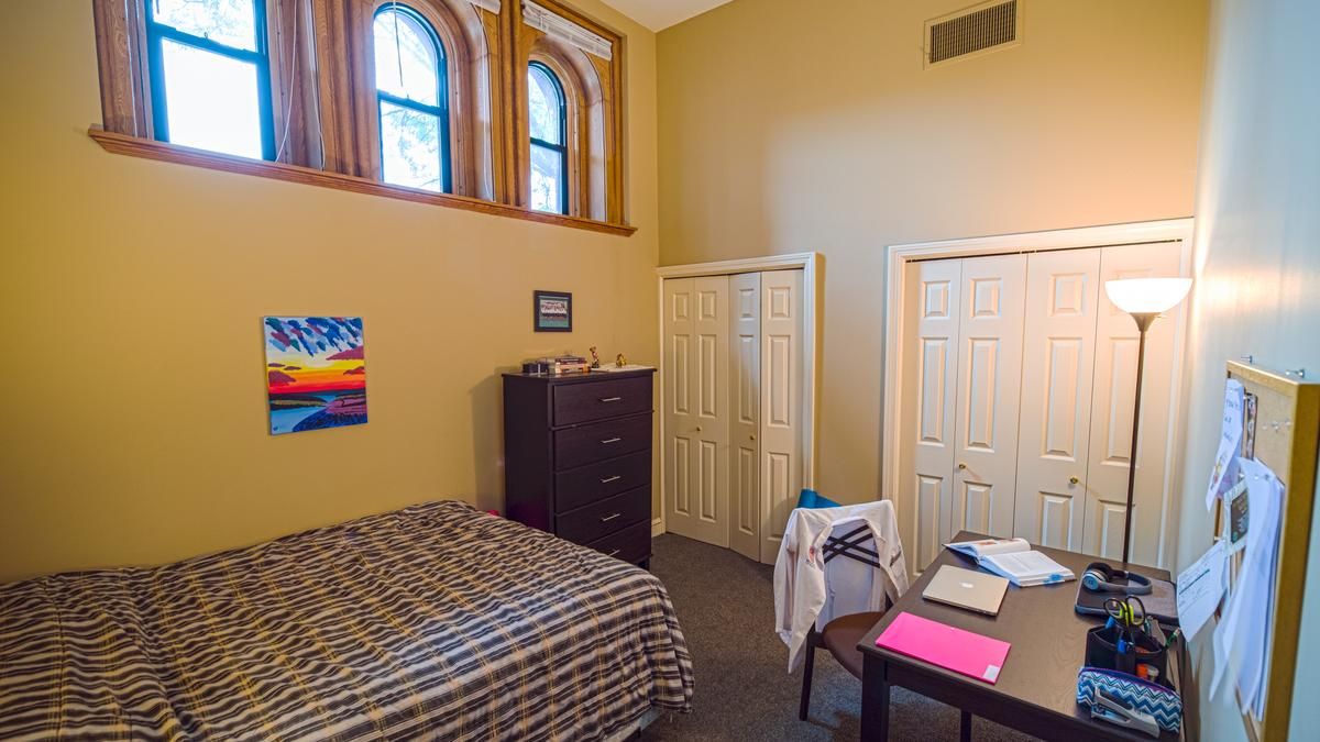 An example of a bedroom with big bed and windows. 